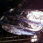 Beer Braised BBQ Ribs covered in foil in the oven